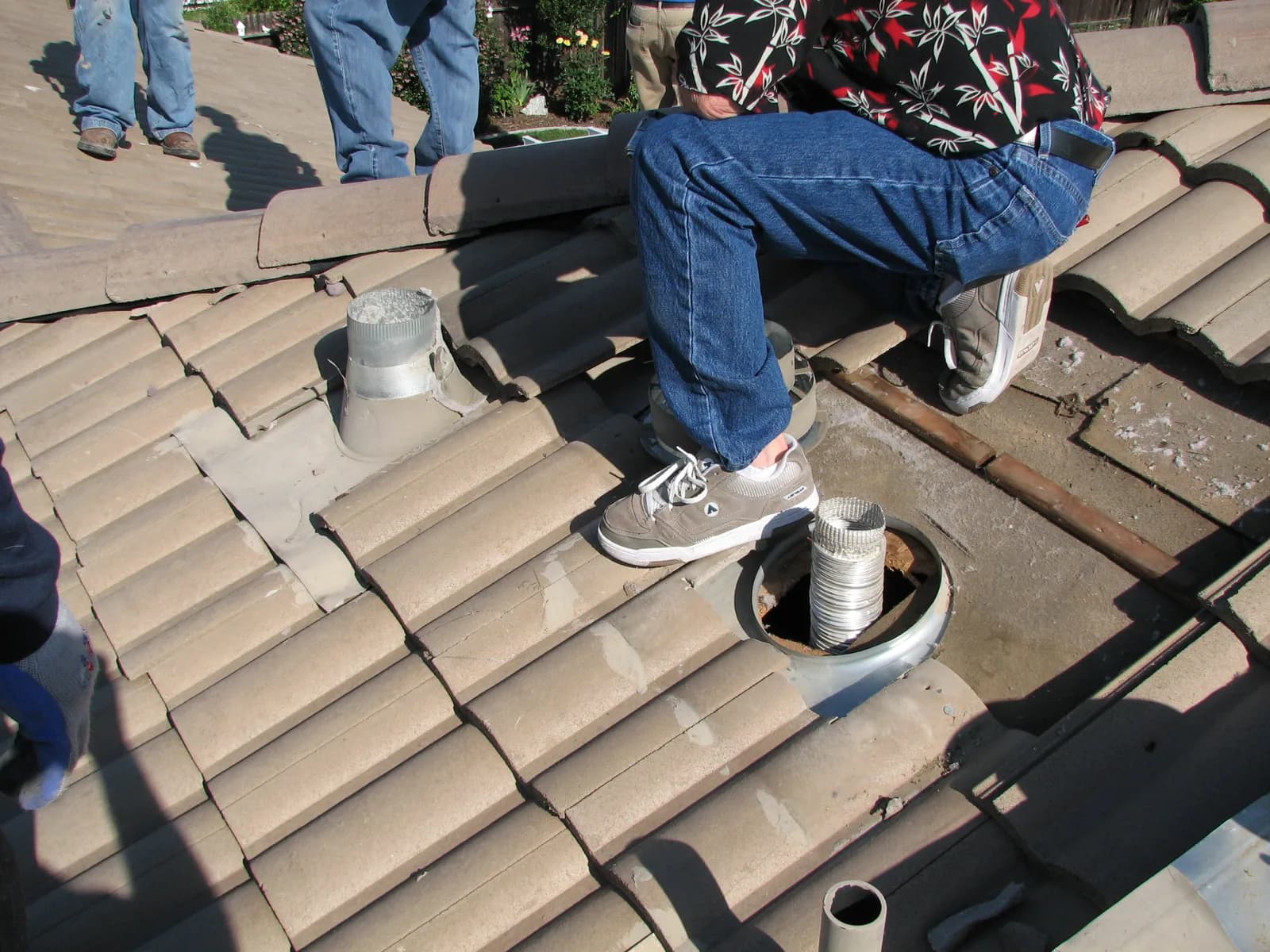 Inspector examining roofing conditions during a field inspection