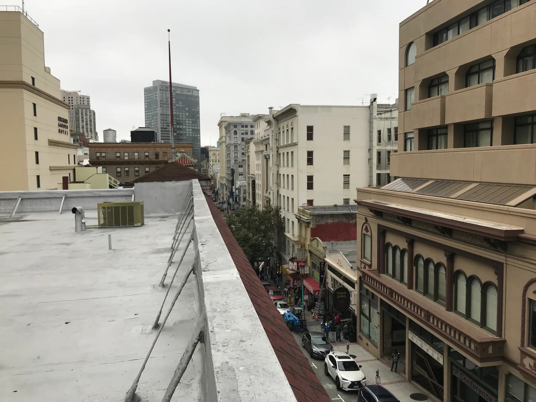 Elastomeric-coated flat roof with rooftop package HVAC unit overlooking a San Francisco street