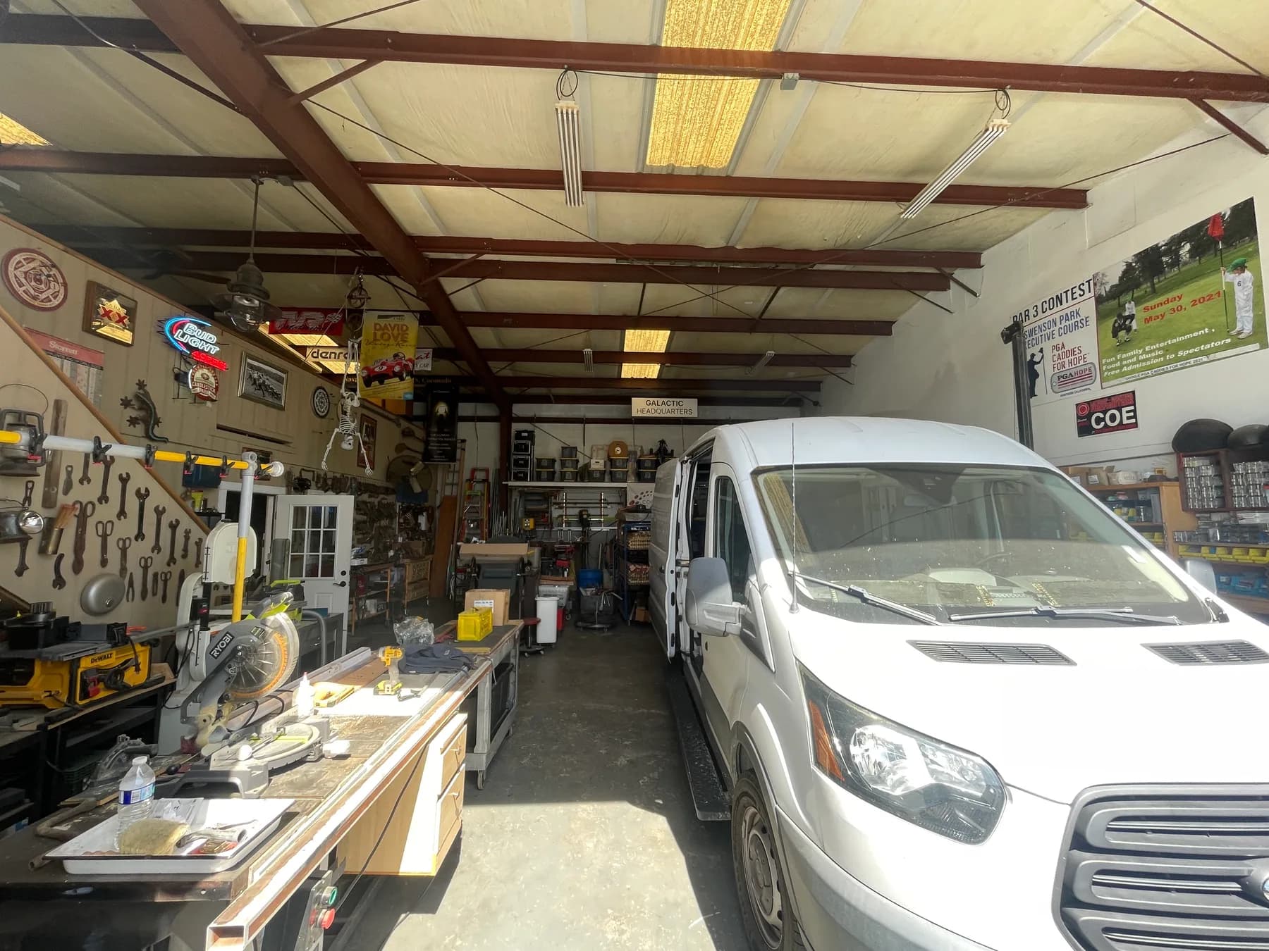 Interior of the Coe & Company shop with work van, workbenches, and racked tools