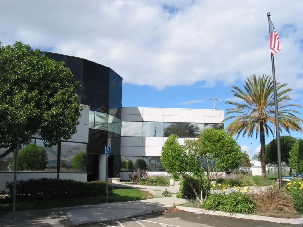 Commercial office building with curved glass facade, subject of construction claims analysis