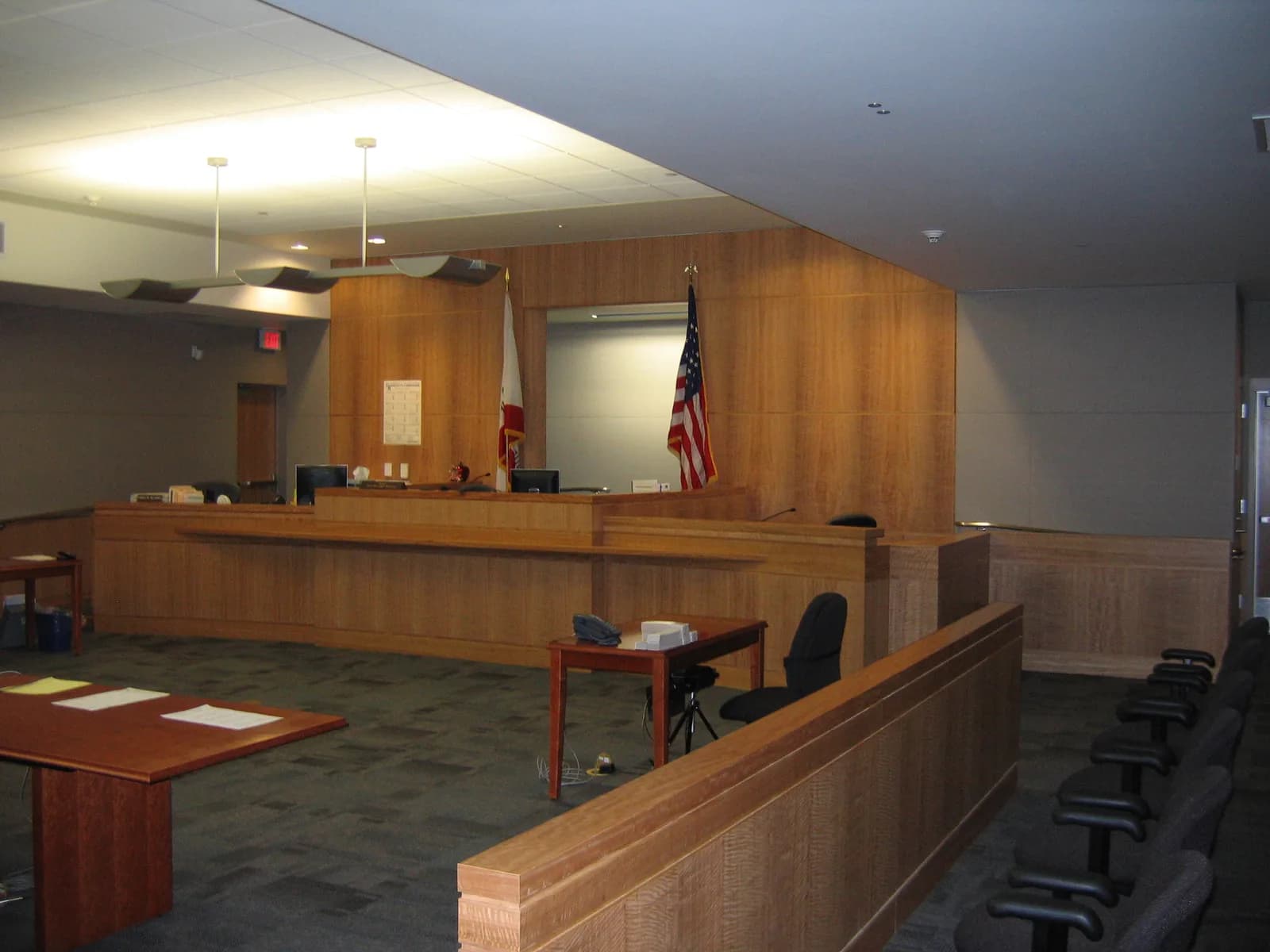 Courtroom witness stand and judicial bench where expert testimony is delivered